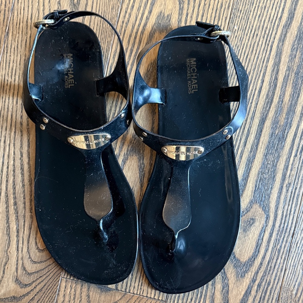 Michael Kors Black Jelly Thong Sandals with Gold Logo Plaque